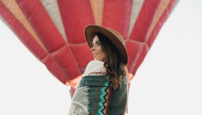 a woman enjoying a hot air balloon ride as part of her bucket list