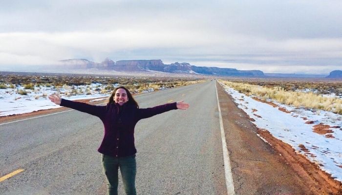 charlotte standing on a highway in monument valley route 66, crazy bucket list idea